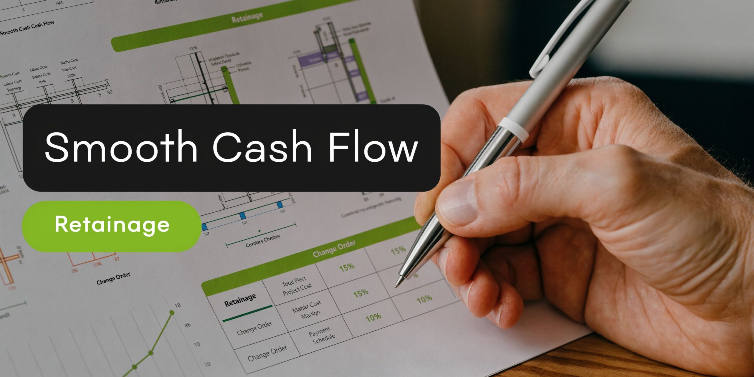 A professional hand writing on a financial document showing construction project cash flow and retainage data.