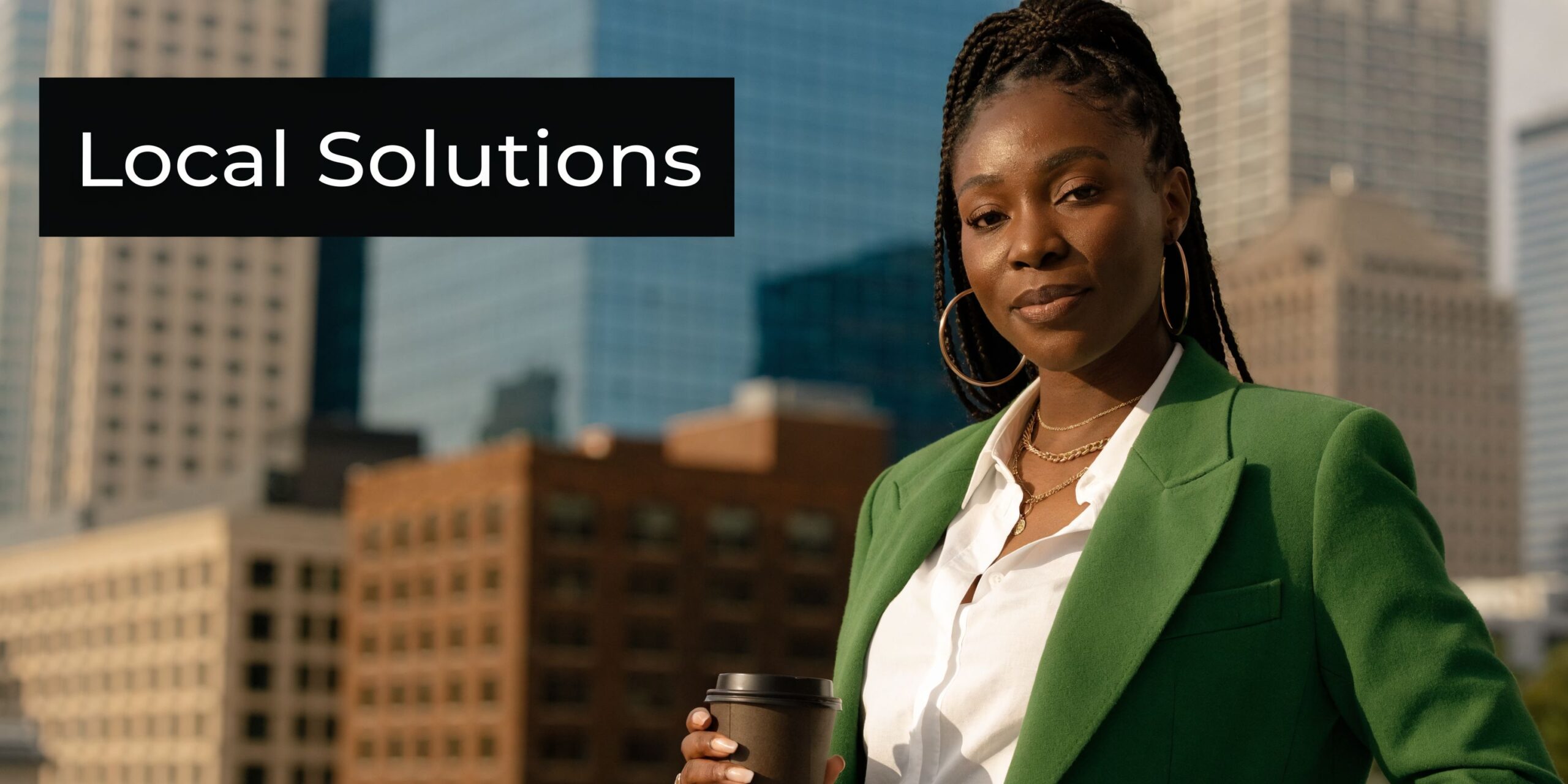 A professional Black woman in a green blazer holding a coffee cup against a city skyline background.