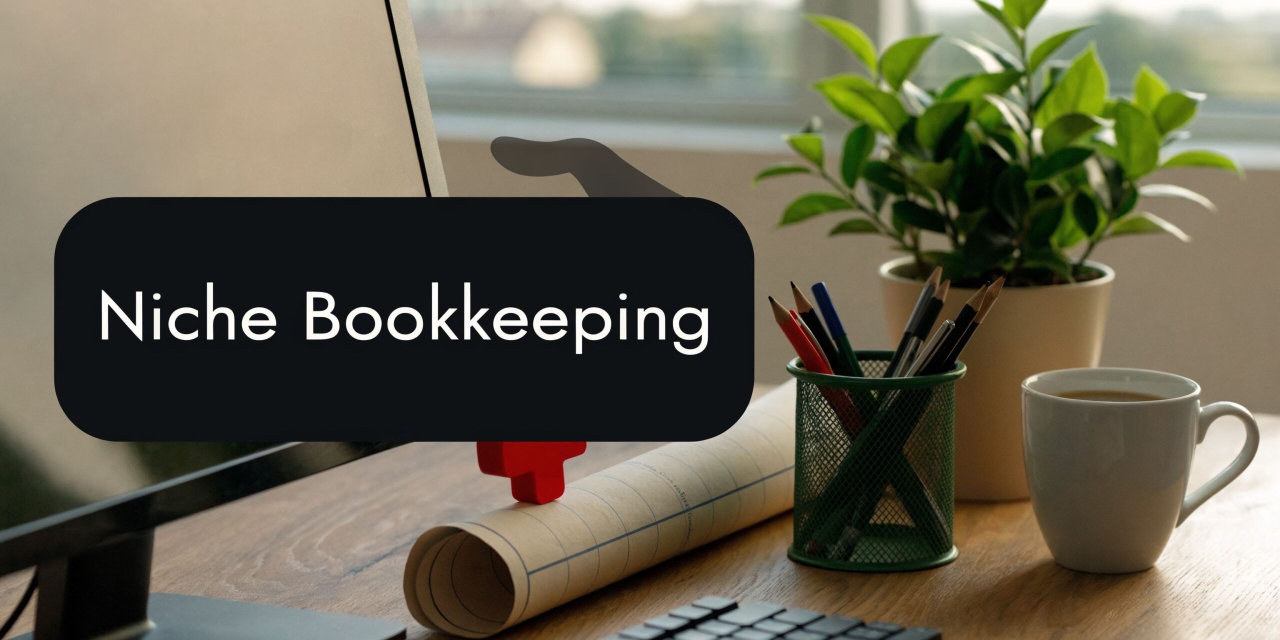 A modern workspace with a computer, pencils, a small plant, and a coffee mug on a desk.