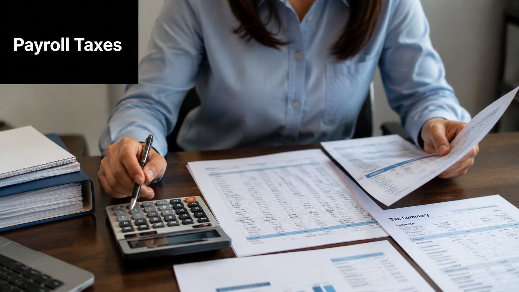 A professional analyzing financial payroll tax documents at a wooden desk with a calculator and files.